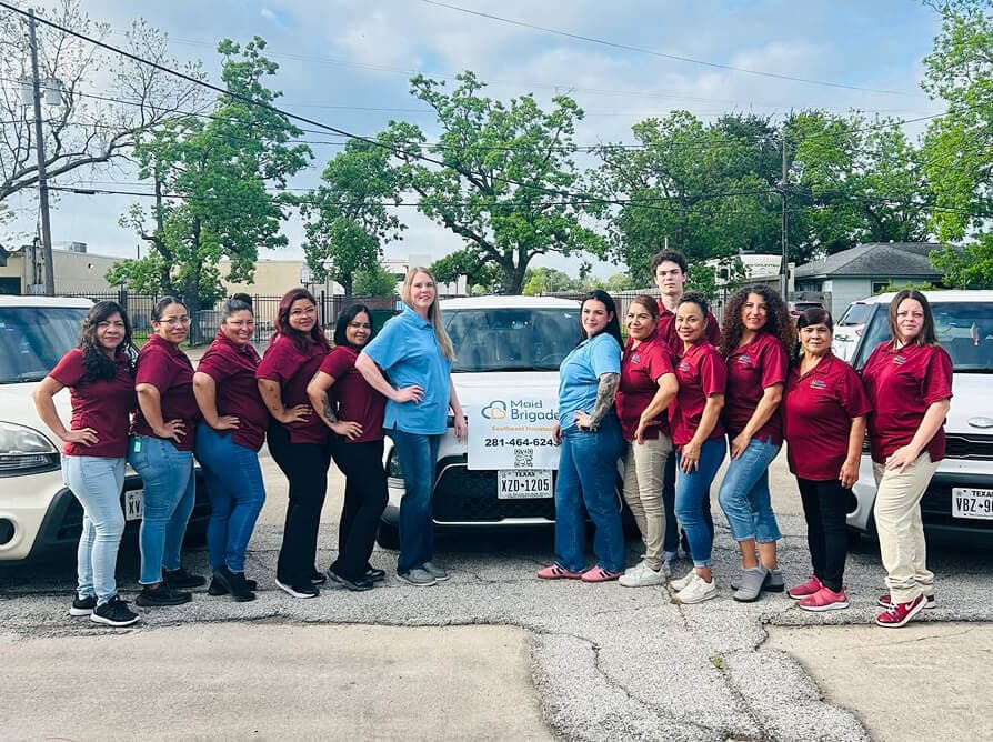 The Maid Brigade SE Houston cleaning team with their company vehicle